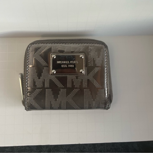Michael Kors Handbags - Michael  Kors Jet Set patent logo debossed zip-around wallet. SILVER METALLIC